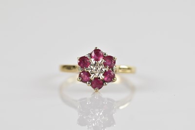 Lot 630 - A 9ct yellow gold cluster ring, with illusion...