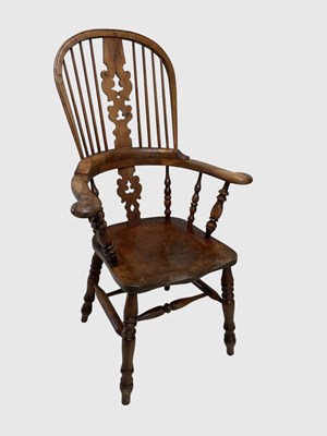 Lot 1069 - A 19th century ash and elm seated Windsor arm...