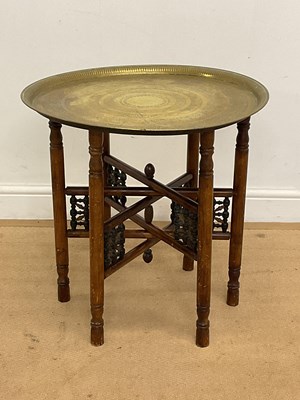 Lot 567 - A Middle Eastern brass and wood circular...