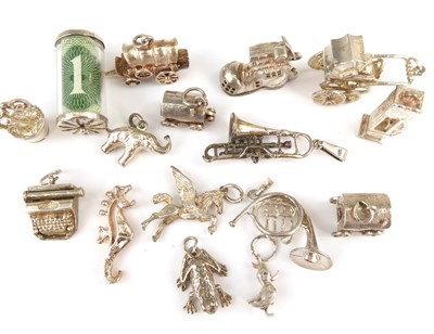 Lot 1064 - Sixteen various charms to include one shilling...