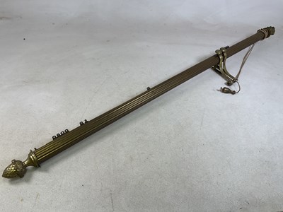 Lot 105 - A brass curtain pole with internal pulley...
