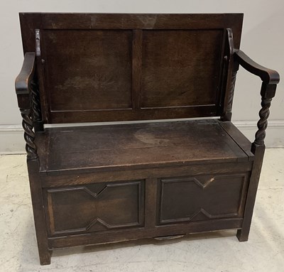 Lot 1120 - A 1920s oak monk's bench, with panelled top...