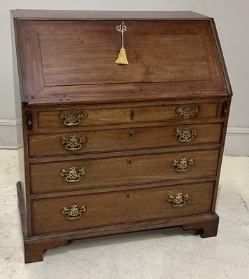 Lot 1124 - A George III mahogany and brass mounted bureau,...