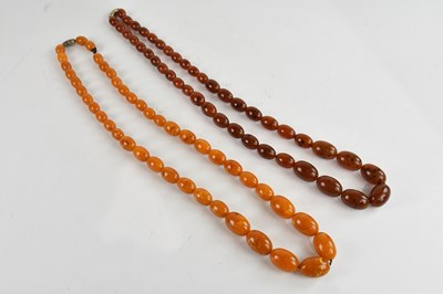 Lot 408 - Two amber coloured bead necklaces, both...