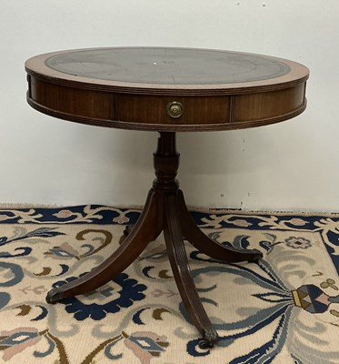 Lot 81 - A reproduction mahogany drum table, with brown...