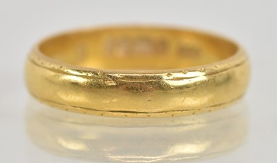 Lot 1244 - A 22ct yellow gold band ring, size K, approx 3....