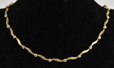 Lot 1332 - A 9ct yellow gold white stone set necklace...