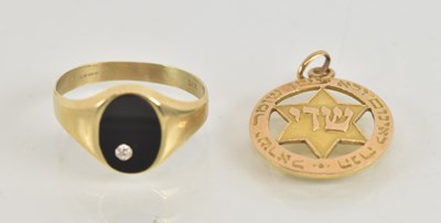 Lot 1255 - A 9ct yellow gold onyx and diamond oval faced...