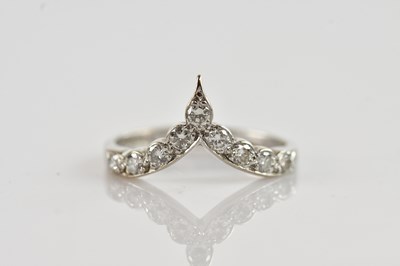 Lot 325 - An 18ct white gold diamond set wishbone ring,...
