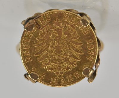Lot 1479 - An 1877 German 5 mark gold coin, in yellow...