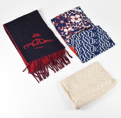 Lot 1260 - COACH; a tan and cream wool square scarf with...
