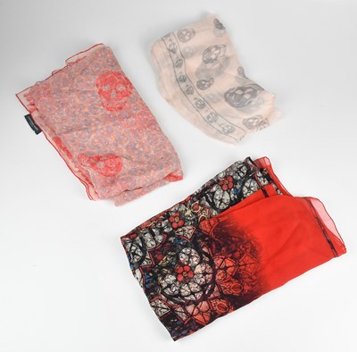 Lot 1221 - ALEXANDER MCQUEEN; a large red silk square...