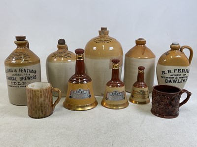 Lot 130 - Five stoneware flagons, all Devon merchants,...