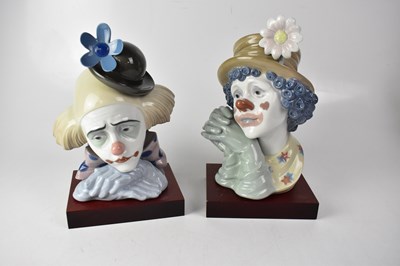 Lot 680 - LLADRÓ; two busts of clowns, raised on wooden...