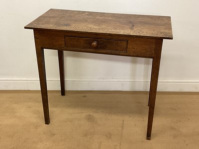 Lot 563 - An early 19th century oak single drawer side...