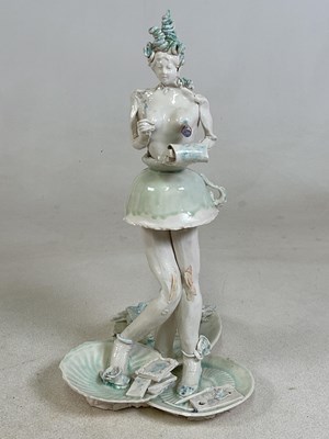 Lot 144 - A porcelain sculpture of a female figure,...