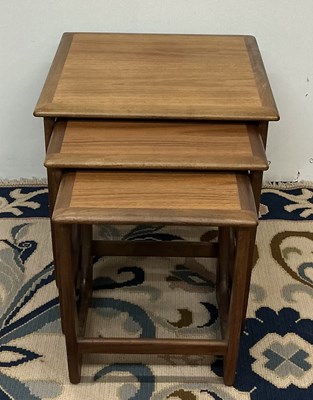 Lot 67 - A mid century teak nest of three stacking...