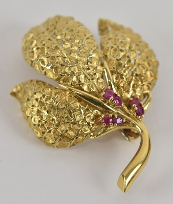 Lot 1387 - An 18ct yellow gold ruby set floral spray...