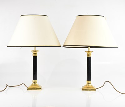 Lot 1306 - A pair of black lacquered and brass lamps,...