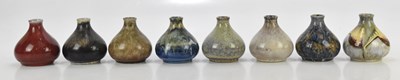 Lot 1182 - COBRIDGE STONEWARE; eight onion shaped vases...