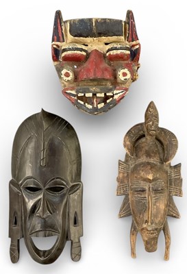 Lot 1080 - A carved tribal mask with polychrome...