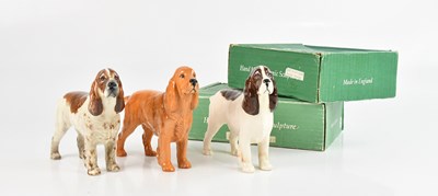Lot 205 - BESWICK; a group of three cocker spaniels, two...