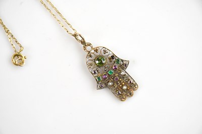 Lot 1555 - A 14k (tested) gold Hamsa hand pendant on...