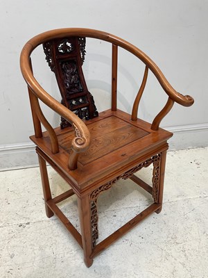 Lot 1125 - A Chinese carved elm and yew horseshoe back...