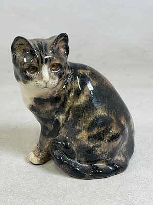 Lot 150 - WINSTANLEY POTTERY; a model of a seated cat,...