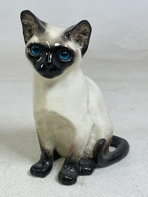 Lot 155 - WINSTANLEY POTTERY; a model of a seated cat,...
