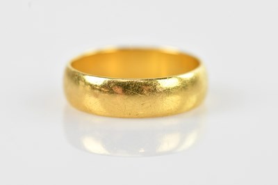 Lot 497 - A 22ct yellow gold wedding band, size M, 5.25g
