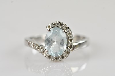Lot 557 - An 18ct white gold diamond and aquamarine...