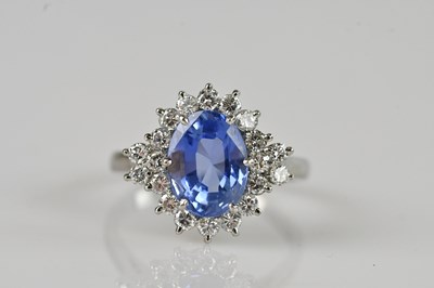 Lot 451 - An 18ct white gold diamond and sapphire...