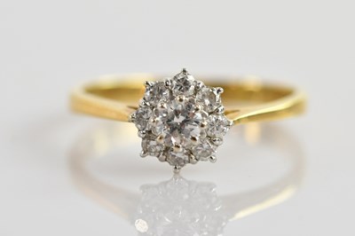 Lot 500 - An 18ct yellow and white gold diamond cluster...