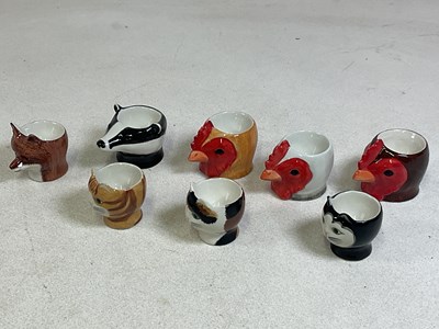 Lot 168 - QUAIL POTTERY; eight eggcups in the form of...