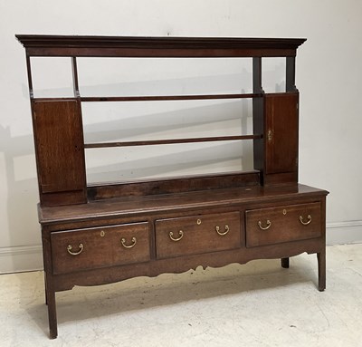 Lot 1045 - An 18th century oak dresser with open back...