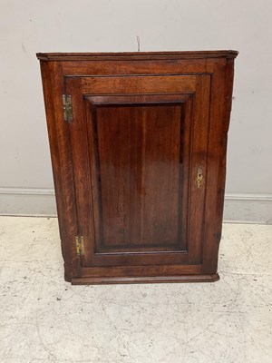 Lot 1195 - An 18th century oak hanging corner cupboard,...
