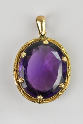 Lot 190 - A yellow metal amethyst set pendant, the oval...