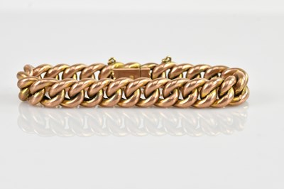 Lot 90 - A rose metal curb link bracelet, stamped '9ct',...