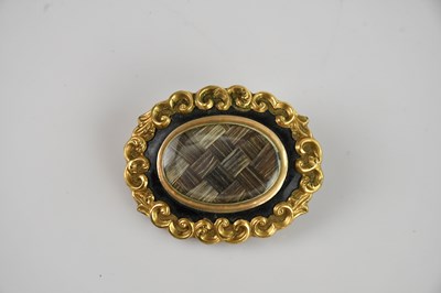 Lot 202 - A Victorian yellow metal black enamel mourning...