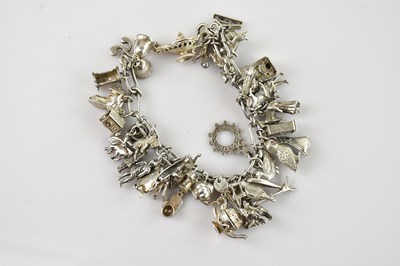 Lot 705 - A hallmarked silver heavy gauge charm bracelet...