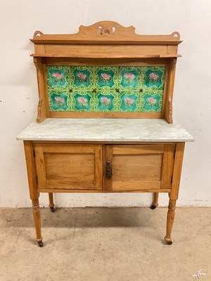 Lot 784 - A marble topped pine wash stand with tiled...