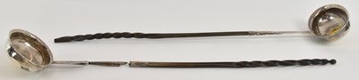Lot 1115 - Two silver punch ladles, both with twisted...