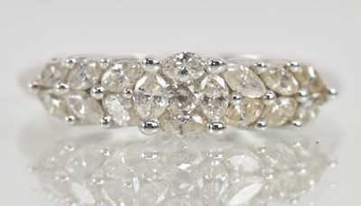 Lot 1235 - A 14K white gold floral diamond set eternity...