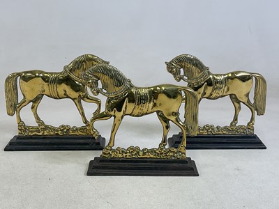 Lot 103 - Three brass doorstops in the form of horses...