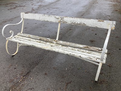 Lot 1154 - A white painted wrought iron and slatted wood...