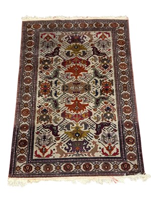 Lot 1216 - A Caucasian hand woven wool rug, worked with a...