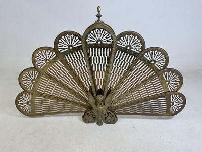 Lot 112 - A brass peacock fan fire guard, height 63cm.