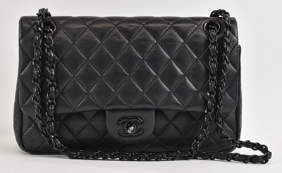 Lot 406 - IN THE MANNER OF CHANEL; a black quilted...