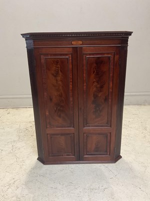 Lot 1038 - A George III mahogany hanging corner cabinet,...